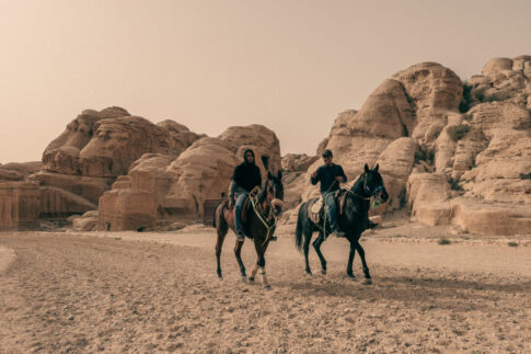 Local bedouins riding horses in Petra